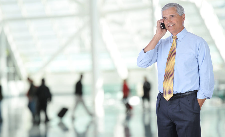 Business professional in a modern office environment talking on a phone.