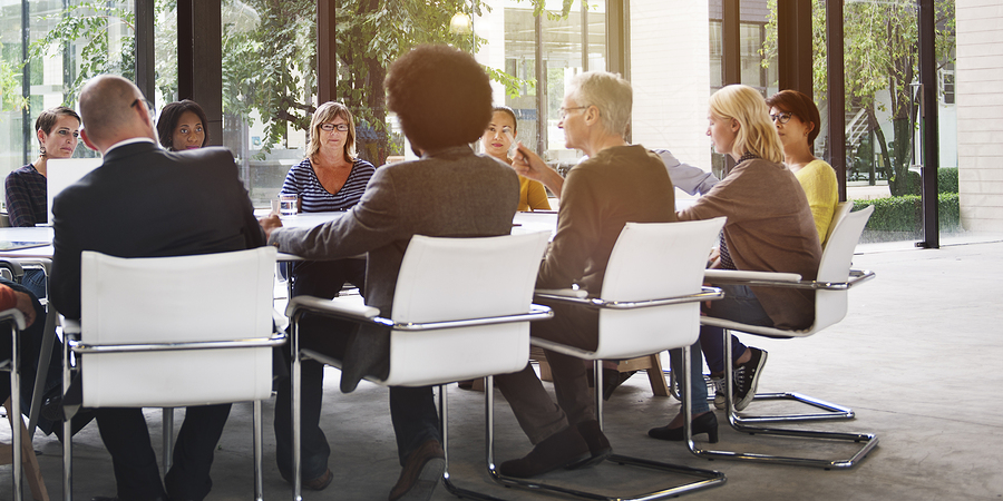 Group of professionals in a meeting room with large windows