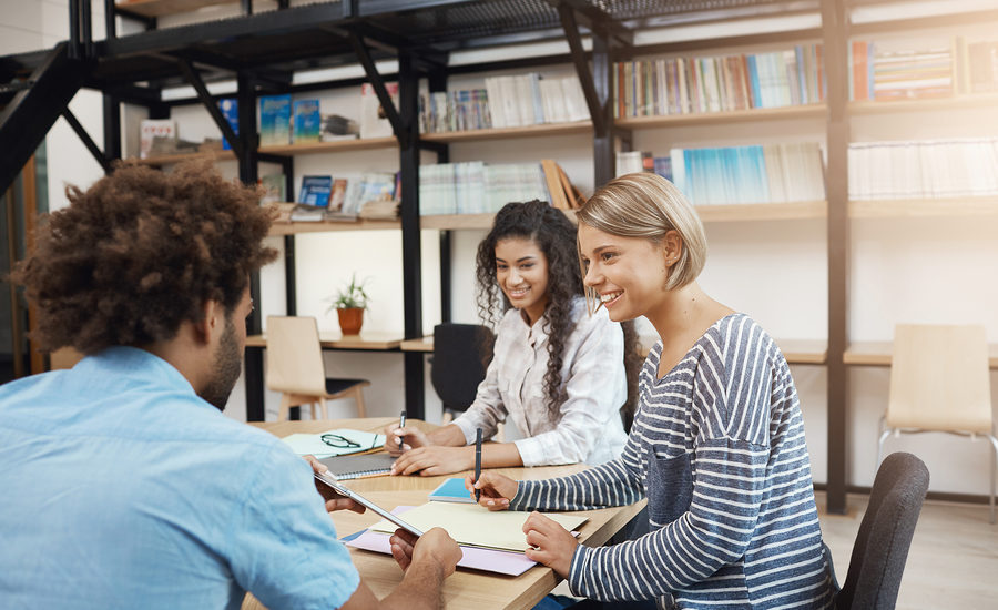 Group of young professionals collaborating in a modern workspace.