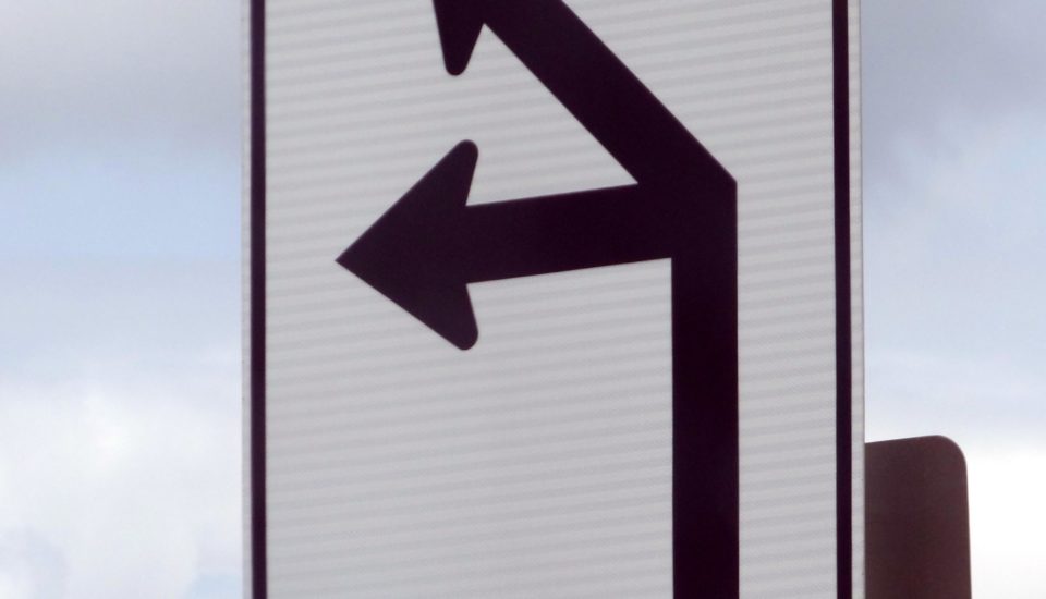 Road sign indicating left or right turn options
