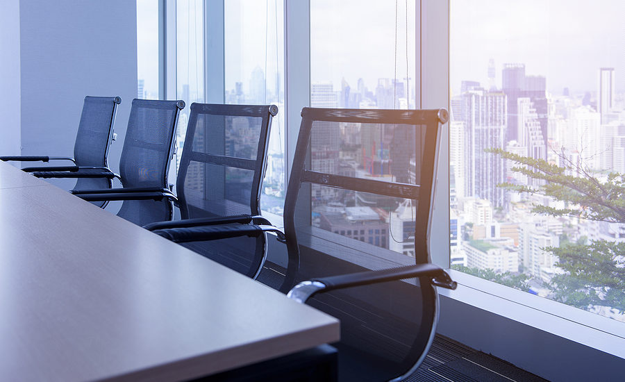 Conference room with modern mesh chairs overlooking a cityscape