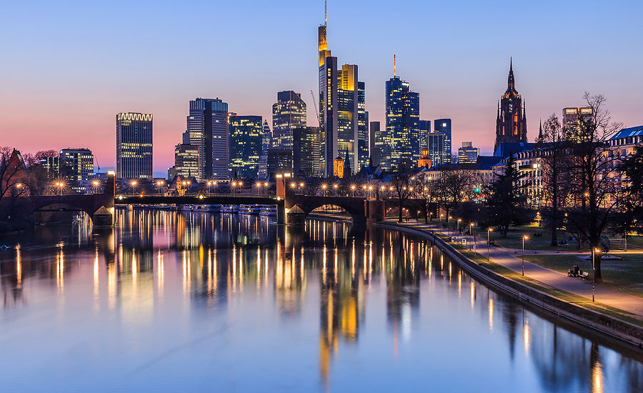 Frankfurt city skyline at sunset with reflections on the river