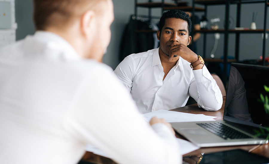 Business professional attentively listening during a discussion in a modern office setting.