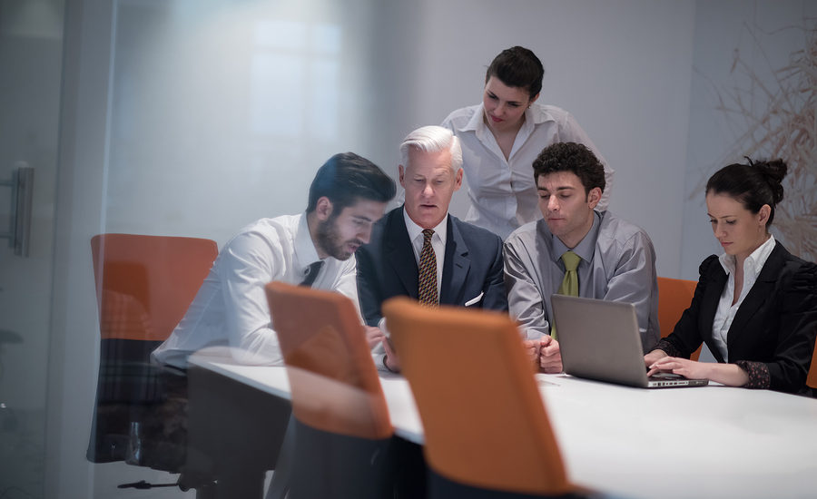 Business team collaborating around a table in a modern office.