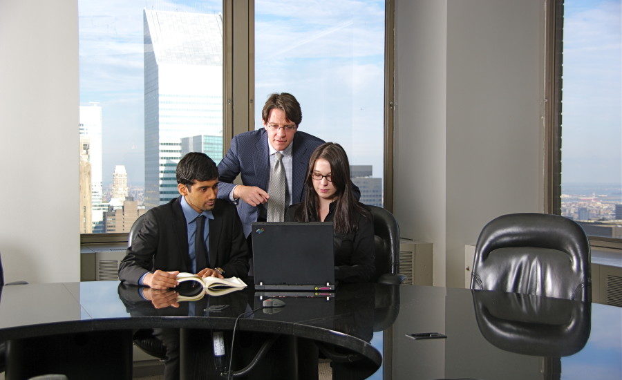 Business team collaborating on a project in a corporate office setting.