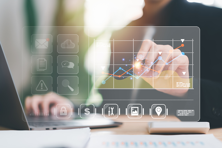 Business person analyzing digital financial data on a touchscreen.