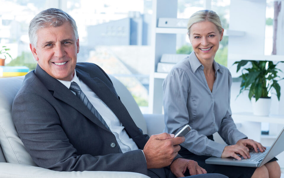 Professional business consultants smiling in an office environment