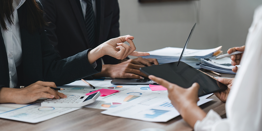 Business team reviewing charts and data during a meeting.