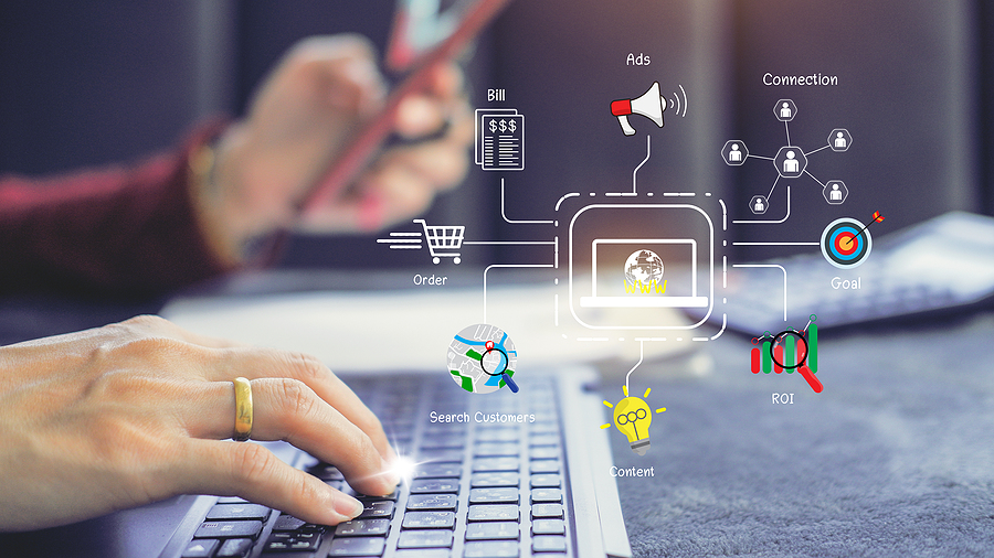 Hands typing on a keyboard with digital marketing icons overlayed, including ads, ROI, and customer search.