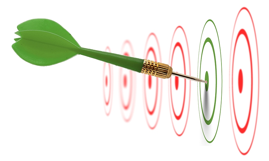 Green dart hitting the bullseye of a green target, surrounded by red targets in the background.