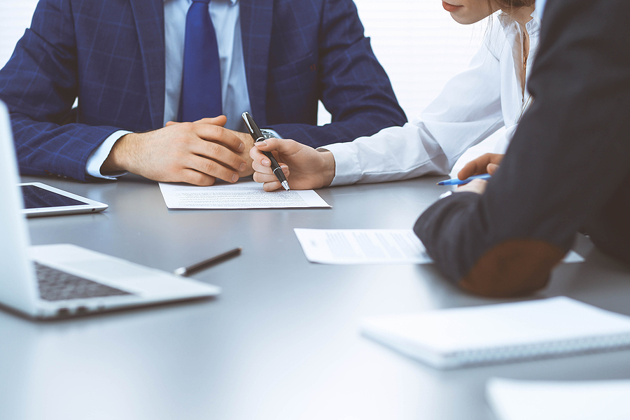 Group of business professionals discussing documents during a meeting