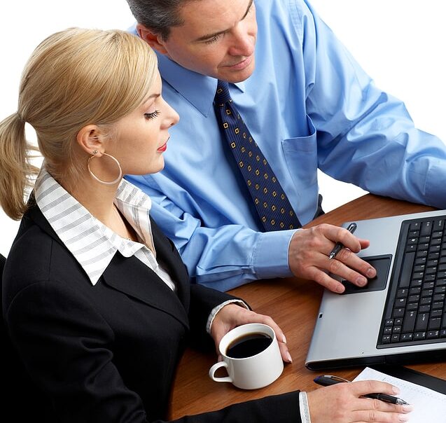 Business professionals collaborating on a laptop