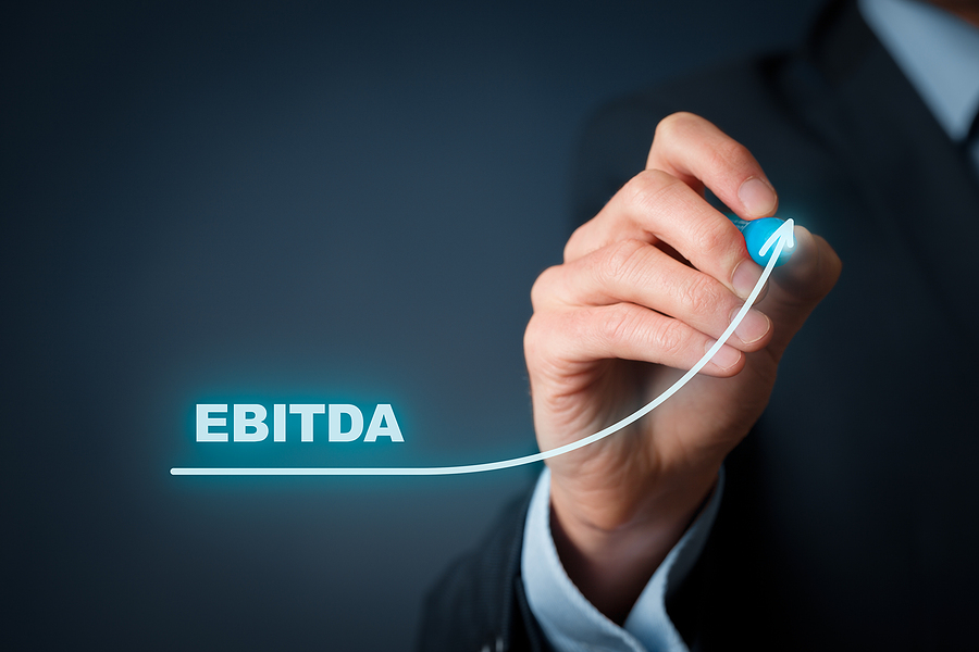 Hand drawing an upward arrow labeled EBITDA, representing financial growth.